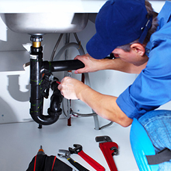 A technician repairing a plumbing system